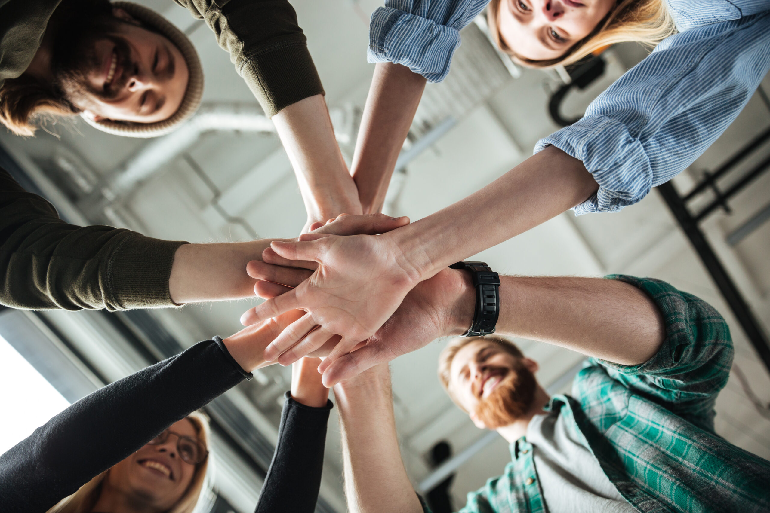 colleagues in office holding hands of each other